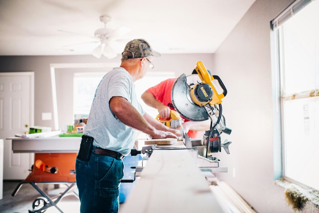 handyman works on new cabinets in a kitchen in elmira, ny