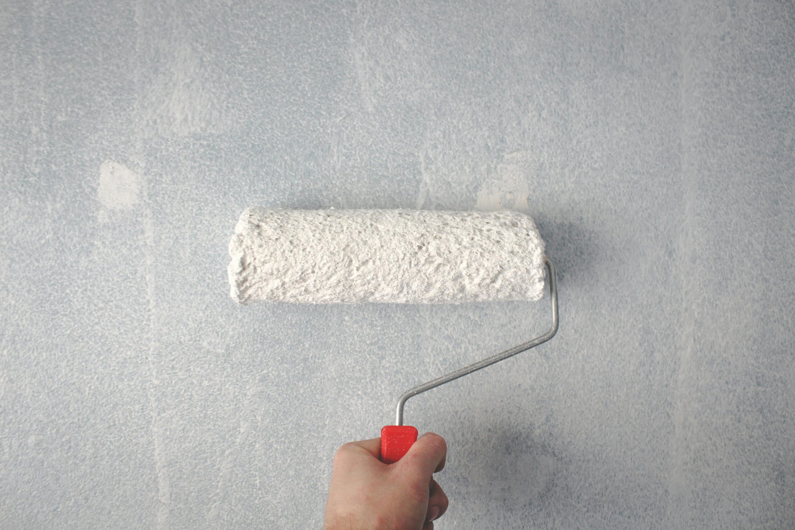 handyman giving a wall a fresh paint job